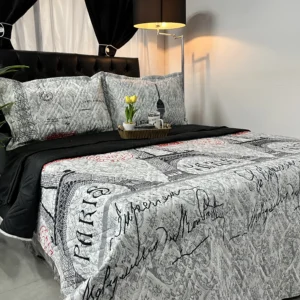 Colcha reversible doble faz modelo Diamant con diseño estampado y reverso unicolor.